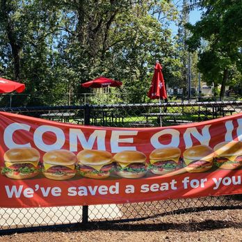 Burgerville - Beautiful outdoor dining in fenced in mini park with tables and umbrellas - Burgers Near Me - West Linn, Oregon Burgerville - Beautiful outdoor dining in fenced in mini park with tables and umbrellas - Burgers Near Me - West Linn, Oregon