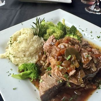 Cafe Venice Restaurant & Bar - Country French Pot-Au-Feu in the foreground - Slow-Roasted Pork Osso Bucco in the background - Wine Bars Near Me - Venice, Florida