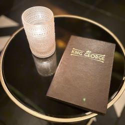 King George Speakeasy - Tables at each seating arrangement.