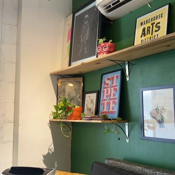 Squeeze Juice Works - a living room with green walls - Juice Bars & Smoothies Near Me - St Petersburg, Florida Squeeze Juice Works - a living room with green walls - Juice Bars & Smoothies Near Me - St Petersburg, Florida