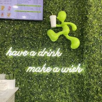 Mr  Wish -  green man with a drink and a sign that says have a drink make a wish - Bubble Tea Near Me - Brooklyn, New York