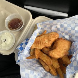 Two piece halibut fish and chips meal with malt vinegar and ranch on the side. Two piece halibut fish and chips meal with malt vinegar and ranch on the side.