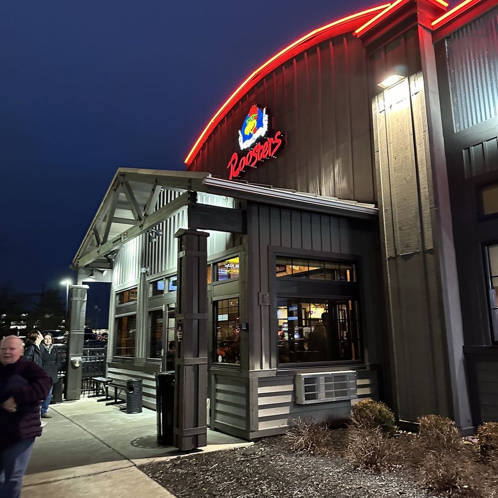 a man walking in front of a restaurant a man walking in front of a restaurant