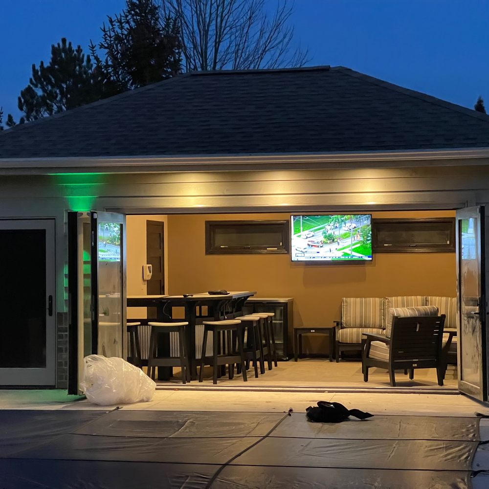 Excel Custom Contractors - a patio with a tv - General Contractors Near Me - Franklin, Wisconsin