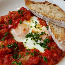 Baked eggs with tomato and chorizo with toasted sour dough bread. Delicious.