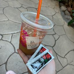  a person holding a drink and a condom