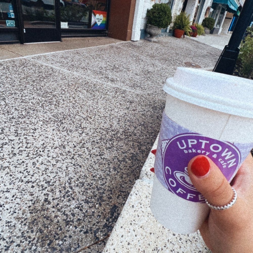 a hand holding a cup of coffee a hand holding a cup of coffee