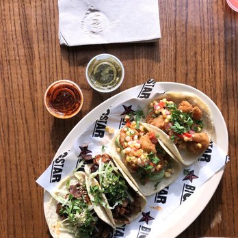 Big Star - a plate of tacos and a drink on a wooden table - Mexican Near Me - Chicago, Illinois Big Star - a plate of tacos and a drink on a wooden table - Mexican Near Me - Chicago, Illinois