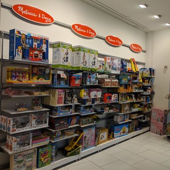 The Game Chest - Store shelving inside and to the right. Toddler interactive toys, such as the ones you might see at Pretend City - Toy Stores Near Me - Irvine, California