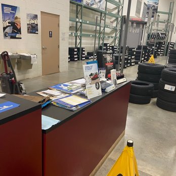 BJ's Wholesale Club - a checkout counter with a yellow caution sign - Grocery Near Me - Raleigh, North Carolina