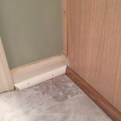 Creative Floorworks - Recommended the wood quarter round to match the cabinet. As you can see it looks like crap.  He did change it to white