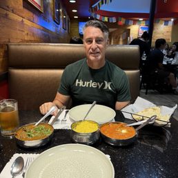 Goat curry, buttered chicken, biryani and garlic cheese naan. Goat curry, buttered chicken, biryani and garlic cheese naan.