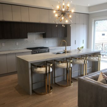 Andre Kitchen and Bath - Modern Kitchen with Austrian Laminate, Quartz Countertops, and Waterfall Center Island https://www.andrekitchenbath.com/ - General Contractors Near Me - Richmond Hill, Ontario