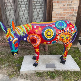 Warehouse 319 - a colorful cow statue in front of a brick building - New American Near Me - Jasper, Alabama