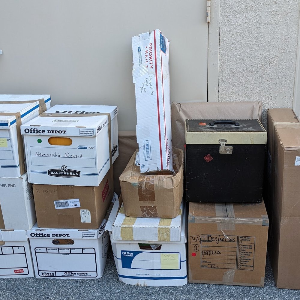 Clear Out Enterprises - Boxes to the left of the storage unit. - Movers Near Me