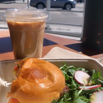Frontier Café - Iced decaf latte with oat milk. Egg sandwich with bacon (minus a few bites). - Coffee & Tea Near Me - Yucca Valley, California Frontier Café - Iced decaf latte with oat milk. Egg sandwich with bacon (minus a few bites). - Coffee & Tea Near Me - Yucca Valley, California