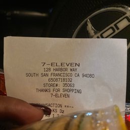 a person holding a receipt in their hand a person holding a receipt in their hand