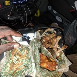 a man eating a meal in a car a man eating a meal in a car