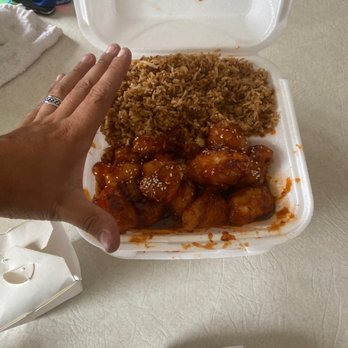 New China Inn - a hand reaching for a container of food - Chinese Near Me - Southgate, Michigan New China Inn - a hand reaching for a container of food - Chinese Near Me - Southgate, Michigan