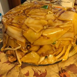 Beef Chow Fun flipped over onto a glass plate. Beef Chow Fun flipped over onto a glass plate.