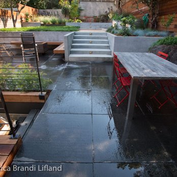 Caffrey Landscapes - a patio with a table and red chairs - Masonry/Concrete Near Me - San Rafael, California Caffrey Landscapes - a patio with a table and red chairs - Masonry/Concrete Near Me - San Rafael, California