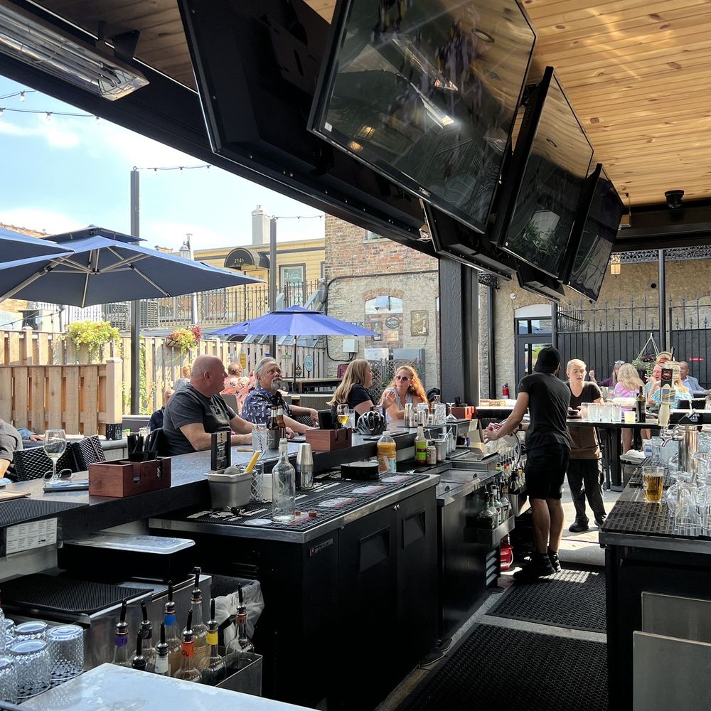 Whiskey Bend - a group of people sitting at a bar - Gastropubs Near Me - St. Charles, Illinois Whiskey Bend - a group of people sitting at a bar - Gastropubs Near Me - St. Charles, Illinois