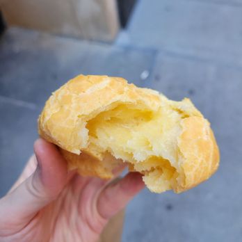 Padoca Bakery - a hand holding a half eaten pastry - Coffee & Tea Near Me - New York, New York Padoca Bakery - a hand holding a half eaten pastry - Coffee & Tea Near Me - New York, New York