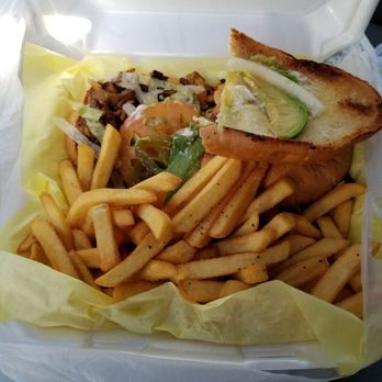 Tortas El Jacalito - A well dressed torta al pastor with fries. - Mexican Near Me - Dallas, Texas Tortas El Jacalito - A well dressed torta al pastor with fries. - Mexican Near Me - Dallas, Texas