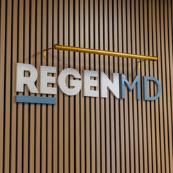 RegenMD Wellness - RegenMD logo on wood panel wall