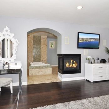 Avalon Studio Design Build - Arched Entrance from Master Bedroom to the Bathroom with 270 degrees Fireplace - General Contractors Near Me - Huntington Beach, California Avalon Studio Design Build - Arched Entrance from Master Bedroom to the Bathroom with 270 degrees Fireplace - General Contractors Near Me - Huntington Beach, California