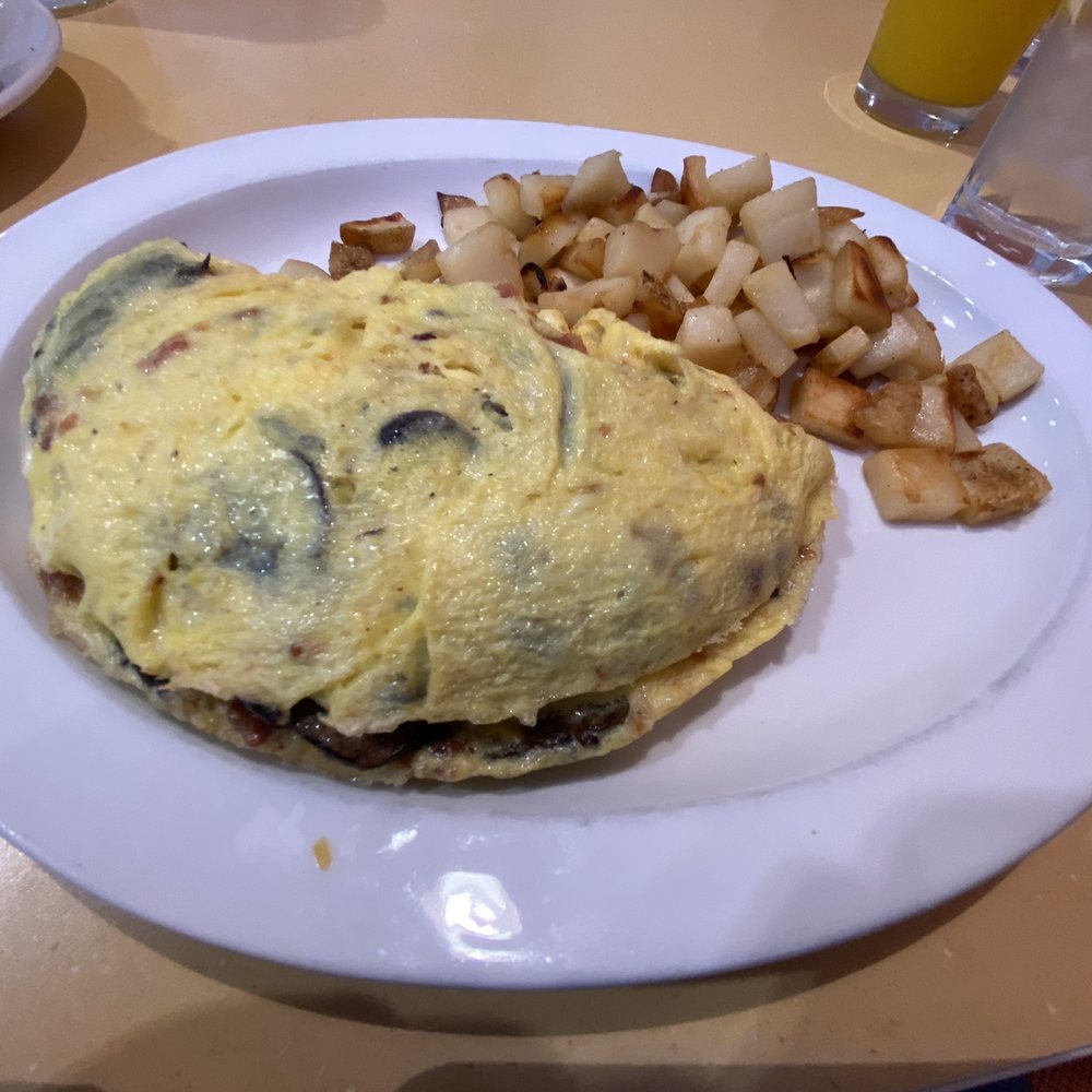 Wild Eggs - Bacon, cheddar jack cheese and mushroom four egg omelet with skillet potatoes. - Breakfast & Brunch Near Me - Carmel, Indiana Wild Eggs - Bacon, cheddar jack cheese and mushroom four egg omelet with skillet potatoes. - Breakfast & Brunch Near Me - Carmel, Indiana
