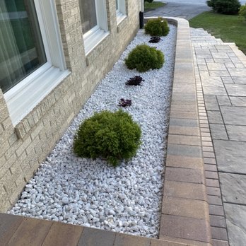 R E Landscaping & Construction - White marble and brick walls and side wall - Landscaping Near Me