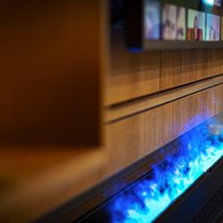 The hand-finished wood cabinetry adds a touch of elegance to any room, while the vapor fireplace provides a stunning ambiance