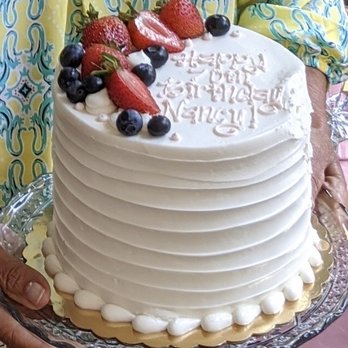 Cotton Leigh Bakery - a woman holding a birthday cake - Bakeries Near Me - Sylva, North Carolina