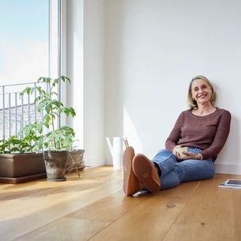 MVDR Flooring - a woman sitting on the floor - Flooring Near Me MVDR Flooring - a woman sitting on the floor - Flooring Near Me