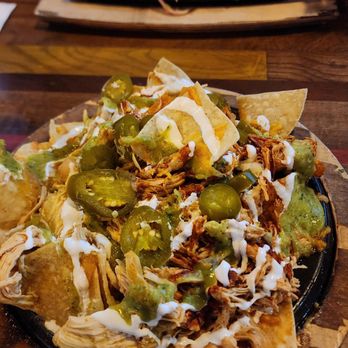 Nacho Daddy - Enchilada Nachos and regular enchiladas in the background. - New American Near Me - Las Vegas, Nevada
