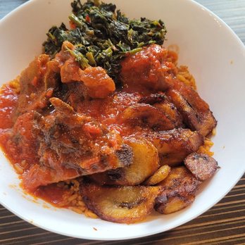 The Village PVD - Jollof rice meal with goat and spinach - African Near Me - Providence, Rhode Island The Village PVD - Jollof rice meal with goat and spinach - African Near Me - Providence, Rhode Island