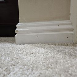 New York Carpets & Flooring - Crooked baseboard with exposed nail holes