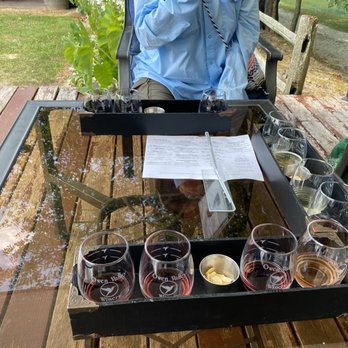 Owen Valley Winery - a man sitting at a table with glasses of wine - Wineries Near Me - Spencer, Indiana Owen Valley Winery - a man sitting at a table with glasses of wine - Wineries Near Me - Spencer, Indiana
