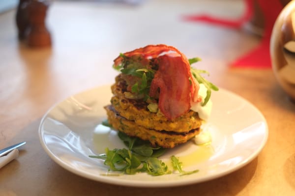 Photo of Lantana Cafe - London, XGL, GB. Corn fritters, streaky bacon, fresh spinach and slow roast tomatoes served avocado chili lime salsa and crème fraiche