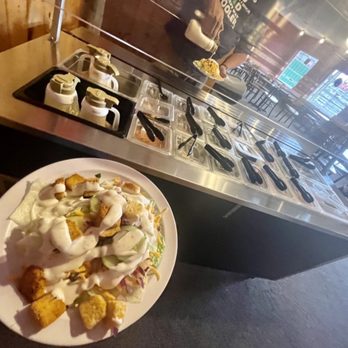 Knappa Pizza and Bar - a person holding a plate of food - Pizza Near Me - Astoria, Oregon Knappa Pizza and Bar - a person holding a plate of food - Pizza Near Me - Astoria, Oregon