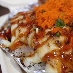 Ocean Taste - Cheesy Crab is kanikama crab leg, house soy glaze, cheese sauce, green onion, and masago.