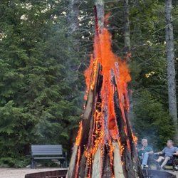 Bonfire and guests looking on music stage.