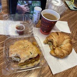 a croissant sandwich and a cup of coffee a croissant sandwich and a cup of coffee