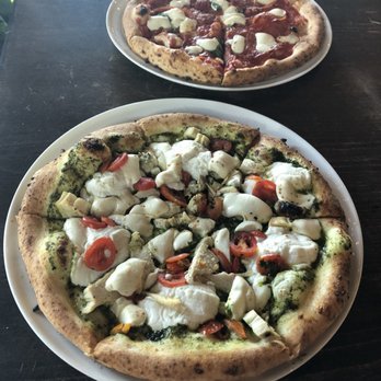 Midici the Neapolitan Pizza Company - Chicken Pesto Pizza (Double Pepperoni Pizza in the back) - Pizza Near Me - Orem, Utah Midici the Neapolitan Pizza Company - Chicken Pesto Pizza (Double Pepperoni Pizza in the back) - Pizza Near Me - Orem, Utah