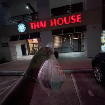 Thai House Restaurant - a hand holding a bag of food - Thai Near Me - Arlington, Texas Thai House Restaurant - a hand holding a bag of food - Thai Near Me - Arlington, Texas