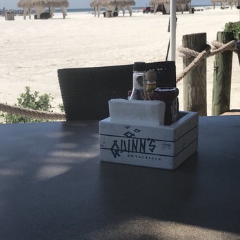 Quinn's - In the background are the Beach Tiki huts that you can reserve- Quinn's has a cart that will deliver drinks & food - Steakhouses Near Me - Marco Island, Florida Quinn's - In the background are the Beach Tiki huts that you can reserve- Quinn's has a cart that will deliver drinks & food - Steakhouses Near Me - Marco Island, Florida