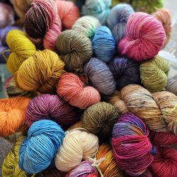 Keep Me In Stiches - Bundle of artesian hand-dyed yarn typical of the shop.