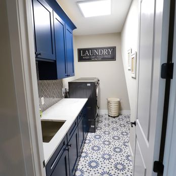 Girka Design Build - a laundry room with blue cabinets - General Contractors Near Me