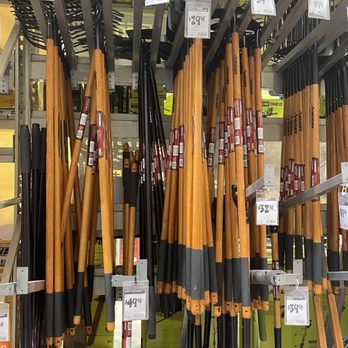 The Home Depot - Garden tools - The image shows a display of garden tools at The Home Depot, including shovels, rakes, and hoes, hanging vertically on a metal rack. Price tags are attached to the handles, indicating their cost. The tools have wooden or black handles, and some have black metal parts. The background includes additional store shelving and product displays, with a focus on outdoor gardening equipment. - Nurseries & Gardening Near Me - Fishkill, New York